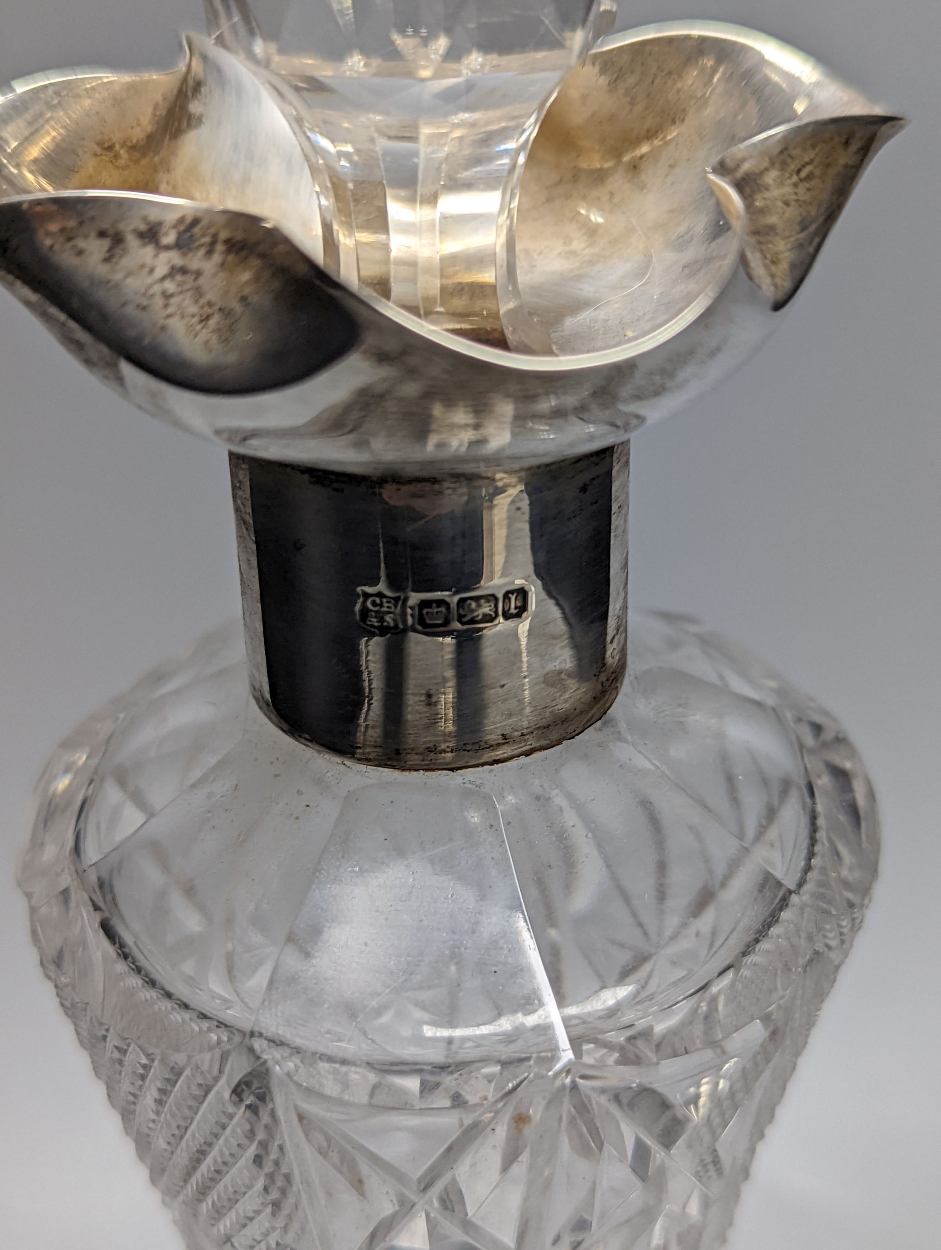 An Edwardian silver mounted cut glass decanter, Sheffield, 1903, 36cm and silver mounted pepper mill.